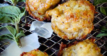 Black pepper parmesan air fryer chicken meatballs served over wide pasta ribbons, lightly crisped on the outside and finished with shaved parmesan.