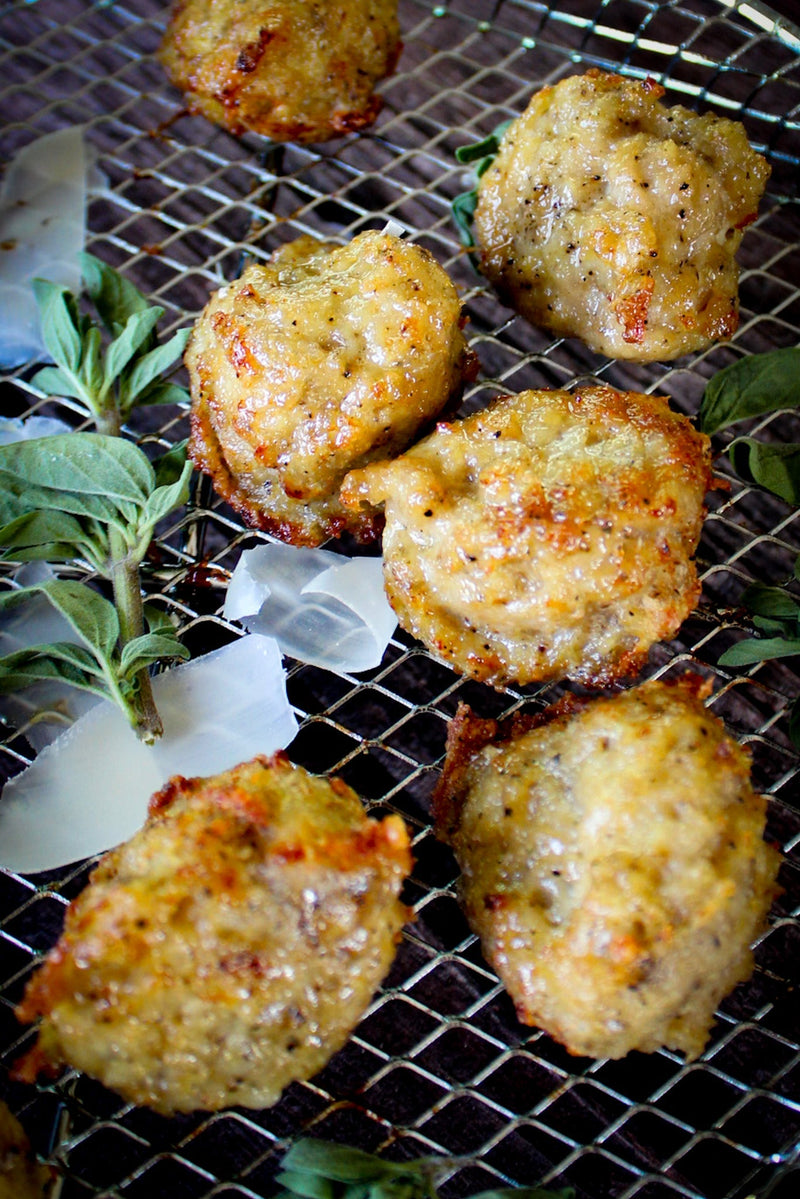 Black pepper parmesan air fryer chicken meatballs served over wide pasta ribbons, lightly crisped on the outside and finished with shaved parmesan.